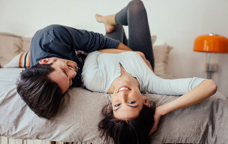 couple-bed-laughing